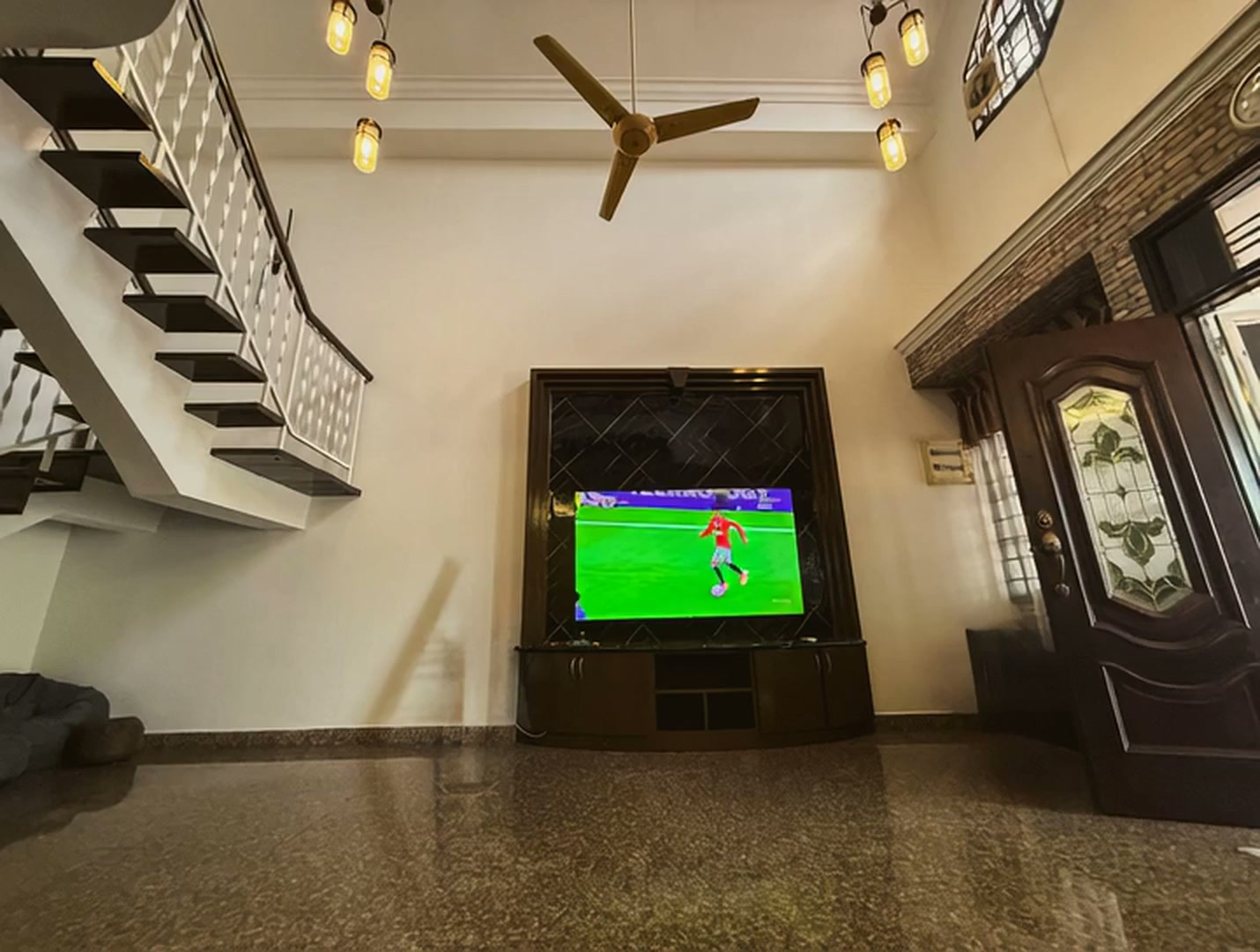 Villa Rinting living hall with television and open staircase